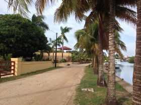 Sidewalk in Placencia, Belize, next to a canal – Best Places In The World To Retire – International Living